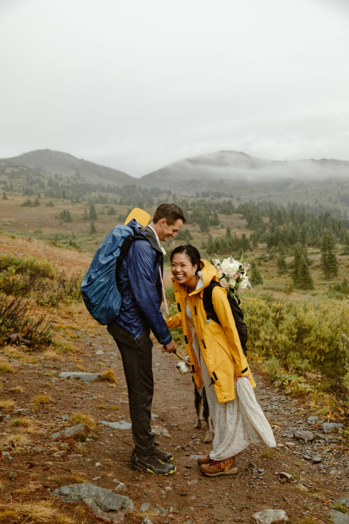 a couple wearing rain jackets during their hiking elopement