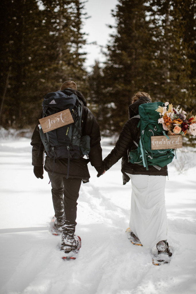 a couple snowshoeing during their colorado winter wedding