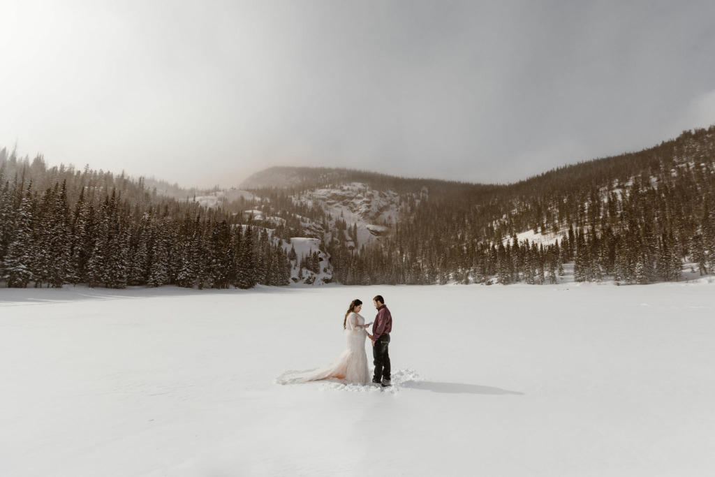 a couple standing on the frozen lake at bear lake during their bear lake wedding