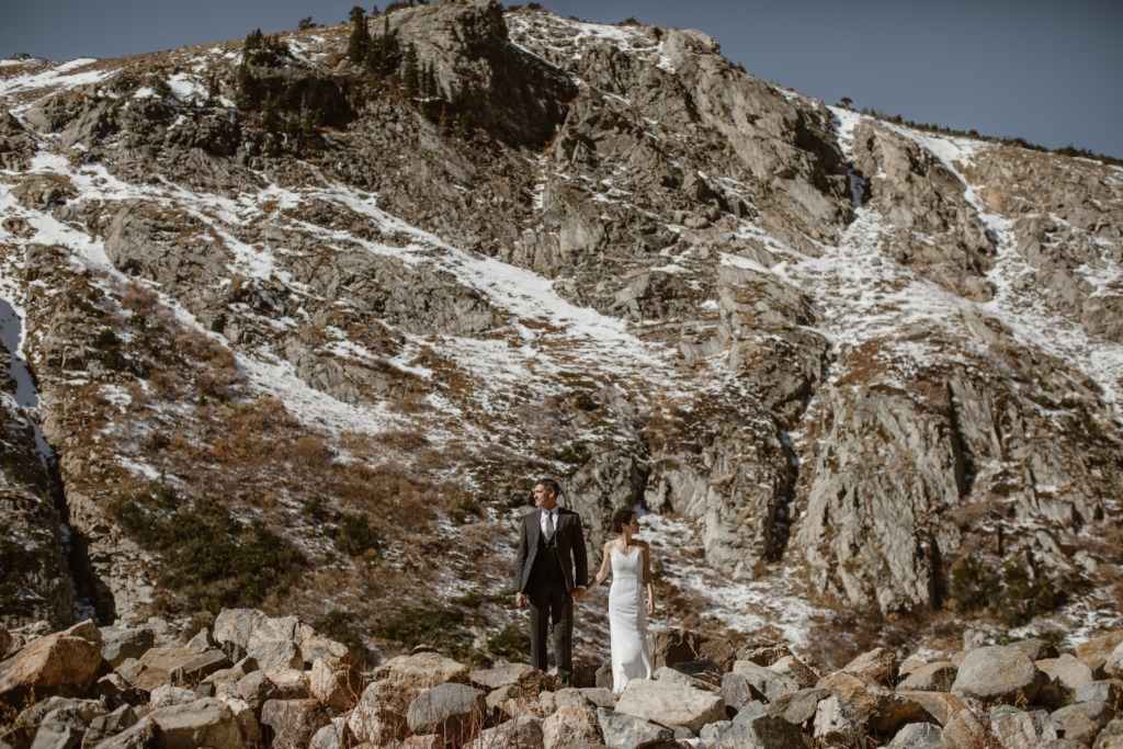 a couple wearing wedding attire at their st mary's glacier elopement