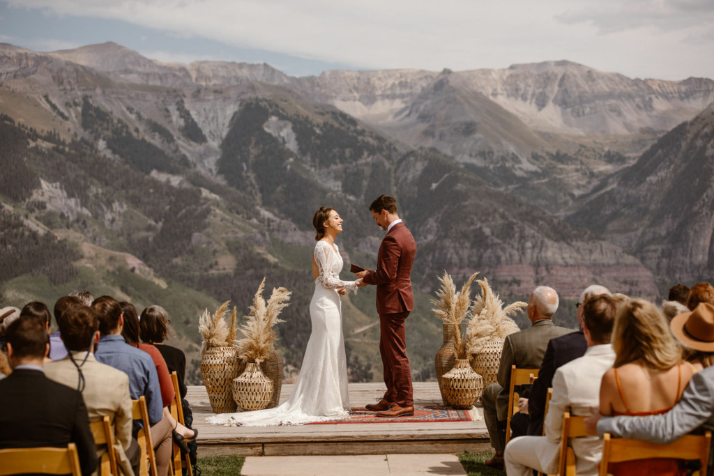 a bride and groom standing on the deck of the san sophia overlook wedding ceremony location