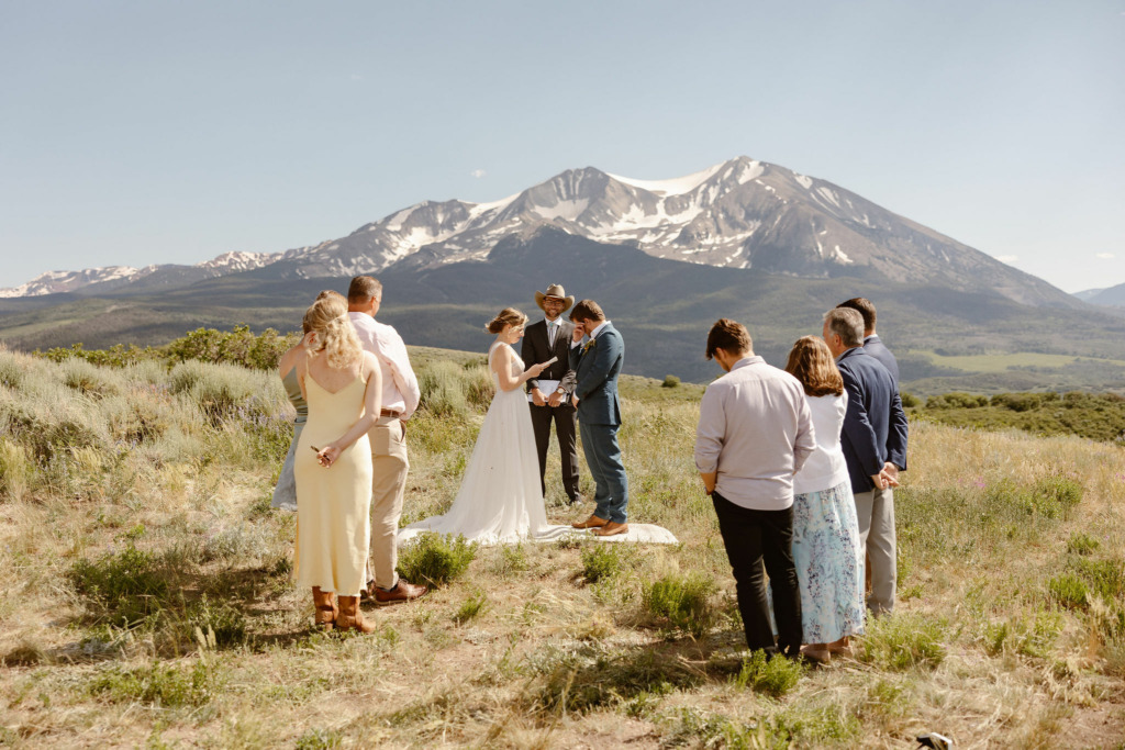 a bride and groom and their small number of guests during their colorado mountain wedding