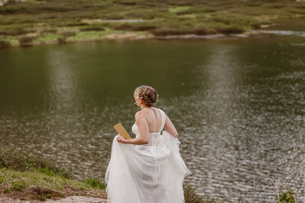 a bride wearing a traditional wedding dress in the mountains during her aspen elopement